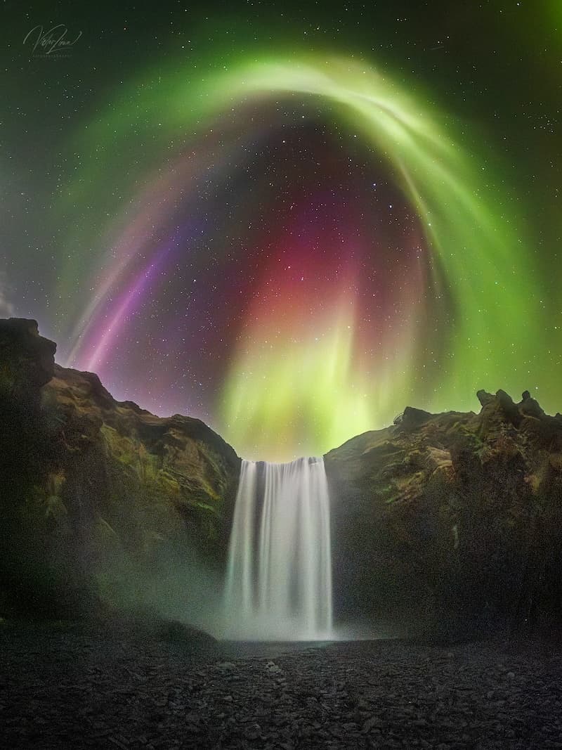 Colorful Aurora over Icelandic Waterfall image